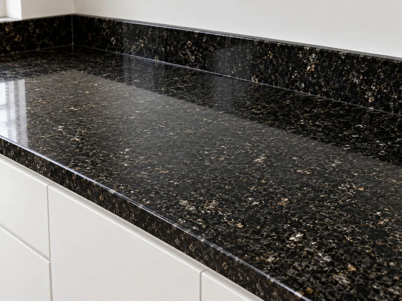 Kitchen worktop and upstand in a black decor with silver and gold flecks